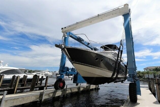 Large yacht in travelift being lowered into the water
