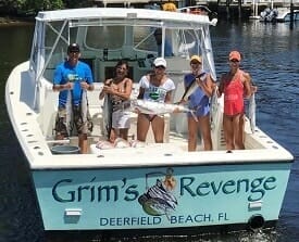 Family aboard Goddess Charter boat with catch